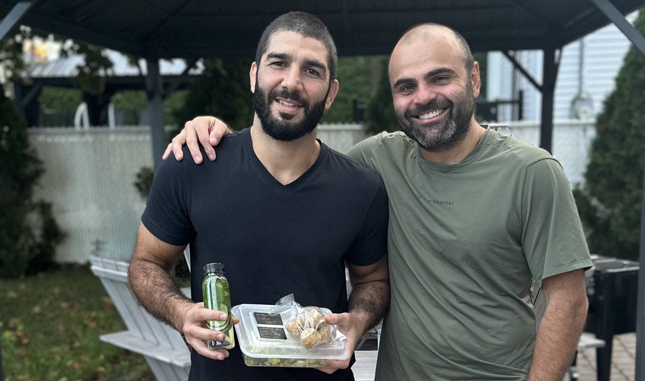 Luigi Meli (a nutritionist in Montreal)  standing together with a client outdoors.