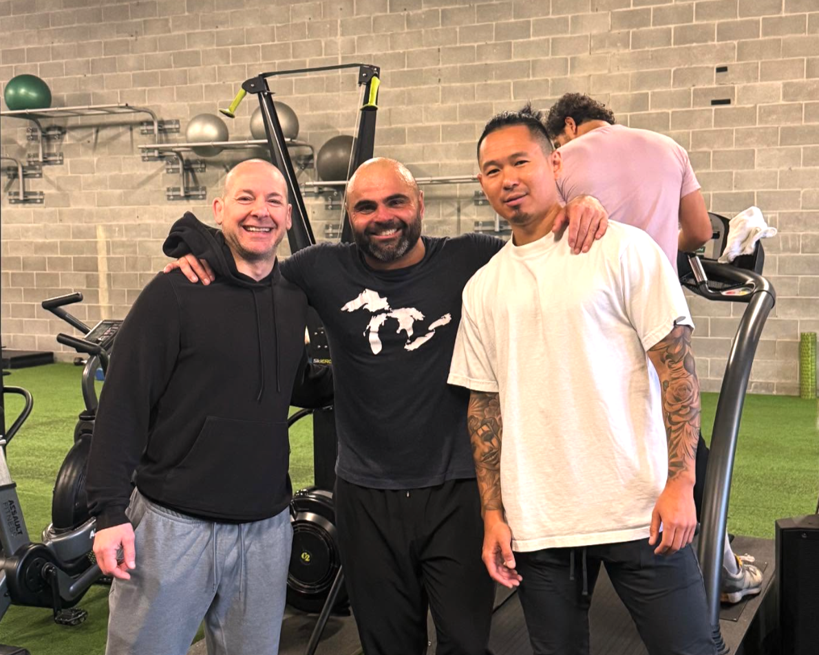 Luigi Meli (Montreal nutritionist) and 2 friends posing together in a gym setting.